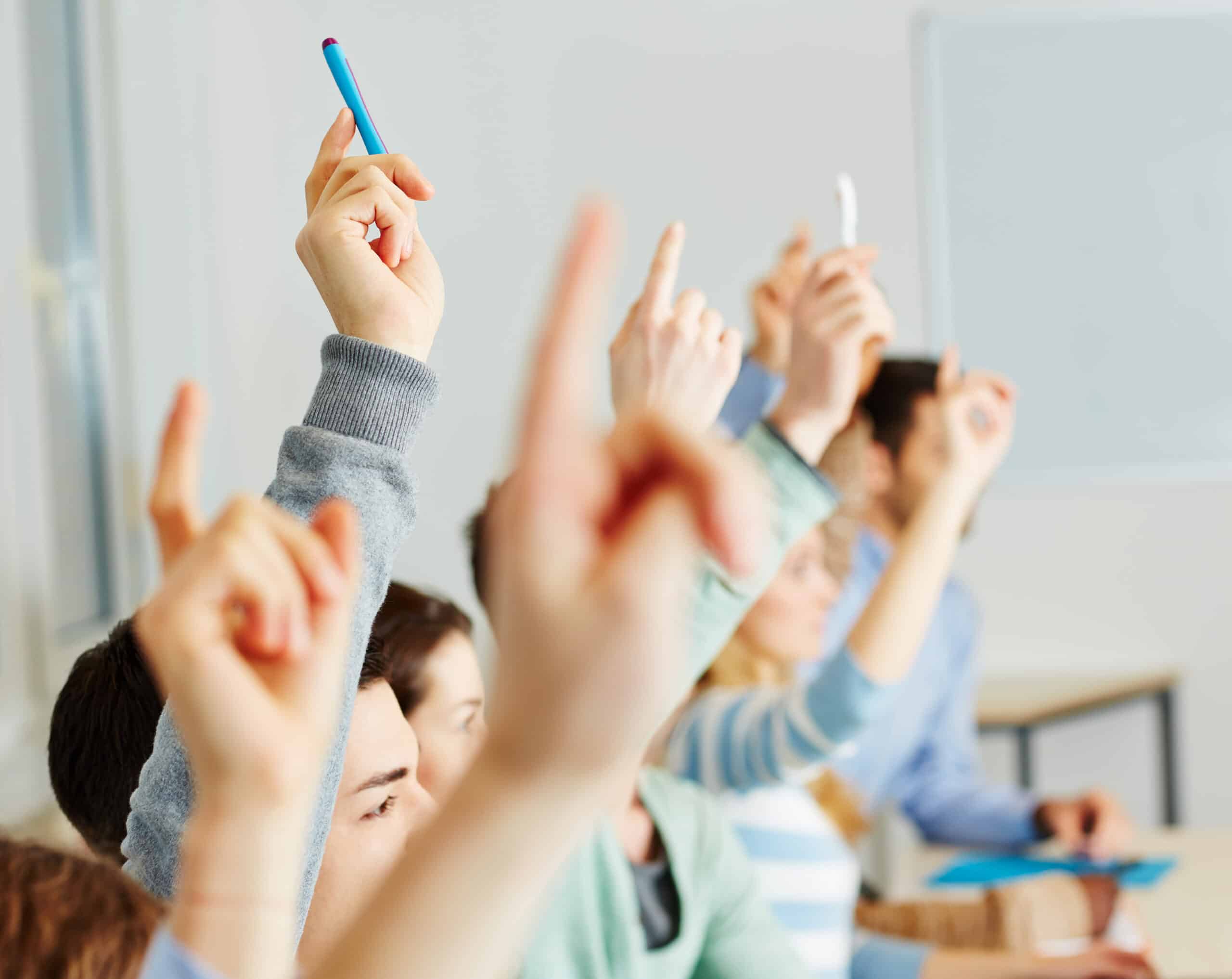 People with questions raising their hands.